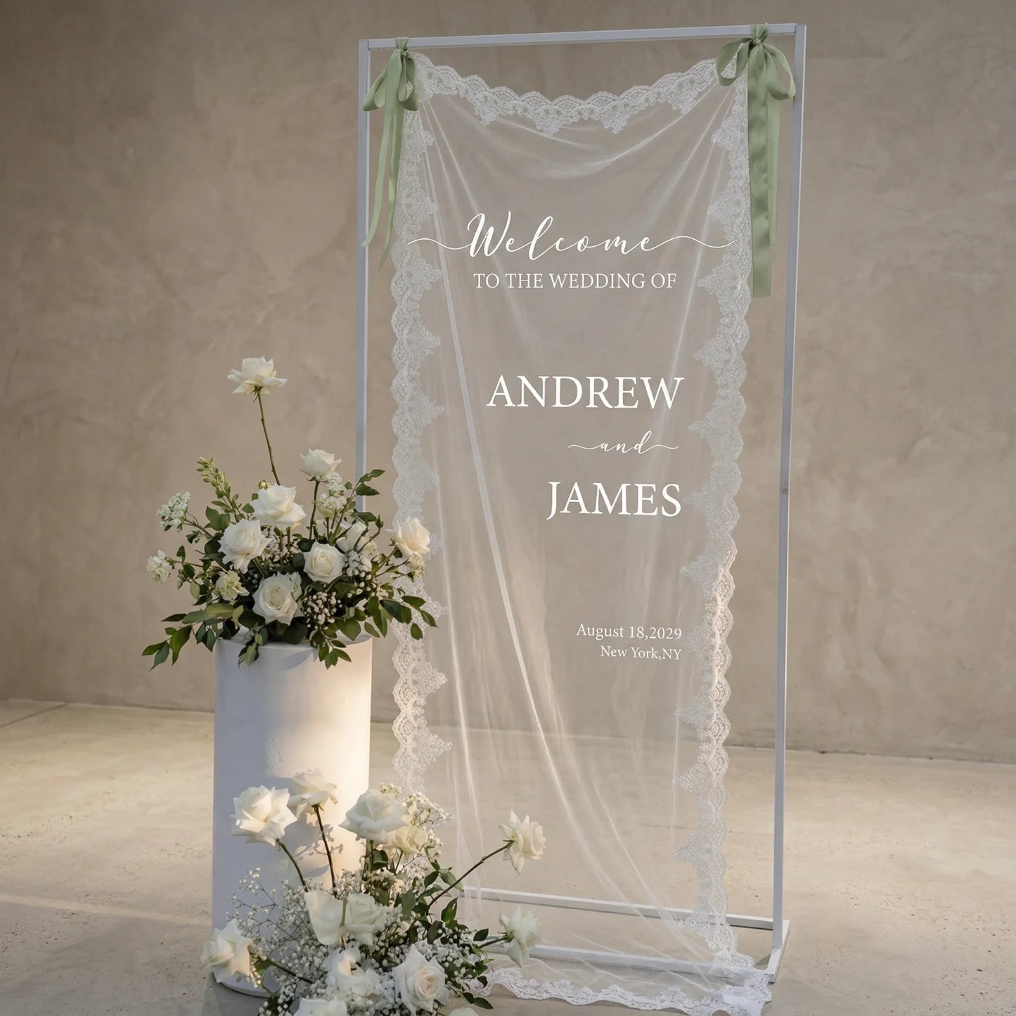 Personalized lace fabric wedding welcome banner with embroidered custom names and date, shown on outdoor ceremony display.