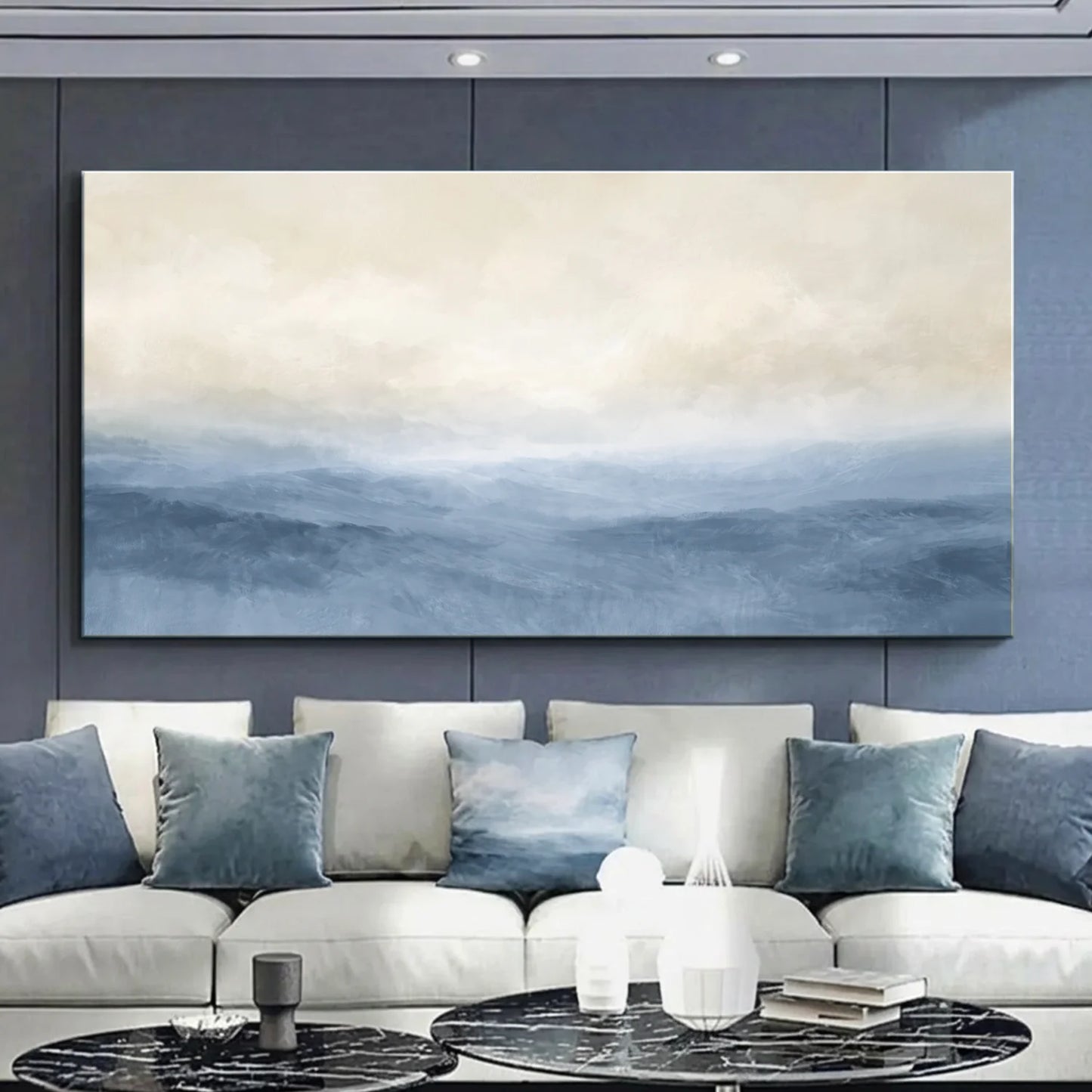 Modern living room with a large abstract painting on the wall above a white sofa with blue cushions. Muted Blue