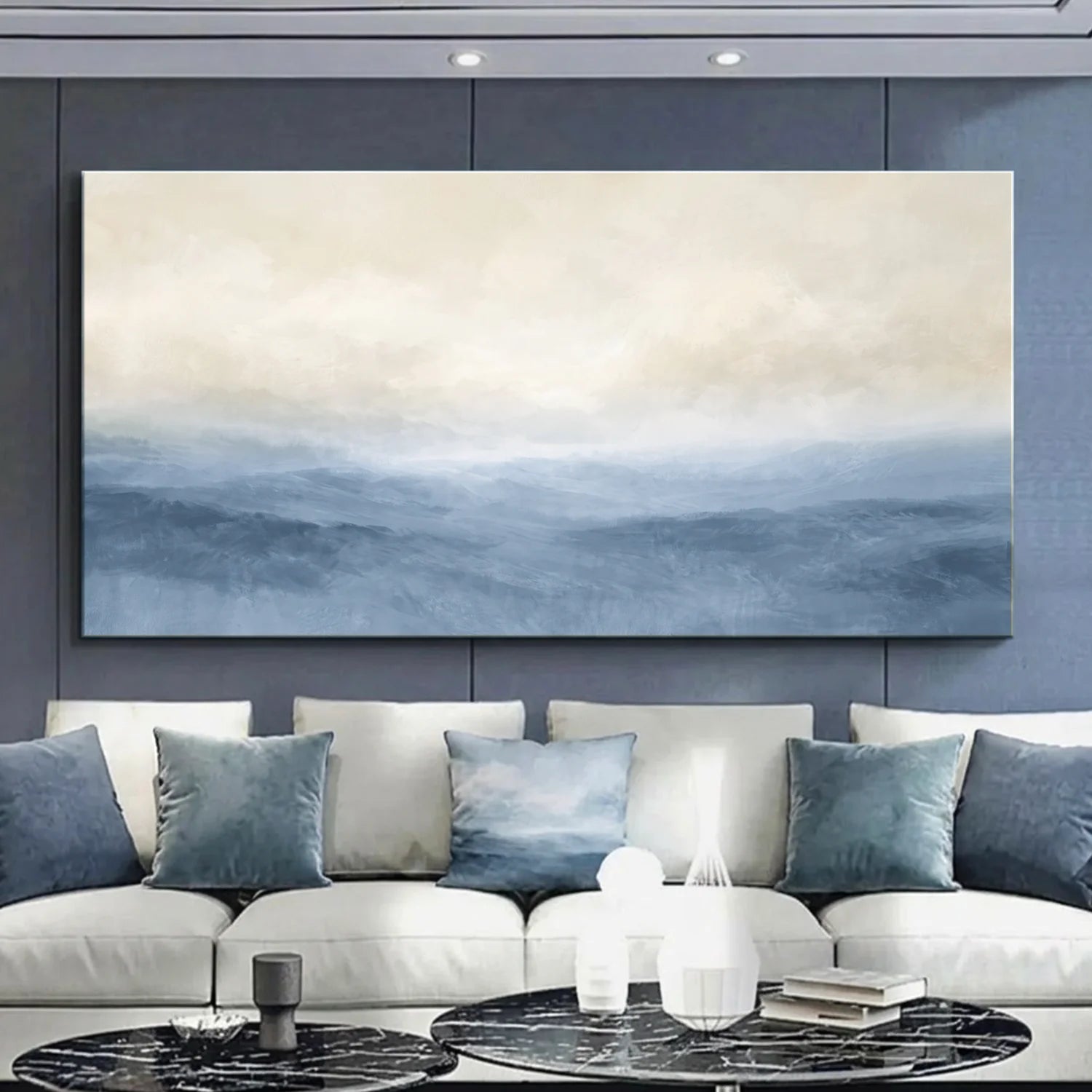 Modern living room with a large abstract painting on the wall above a white sofa with blue cushions. Muted Blue