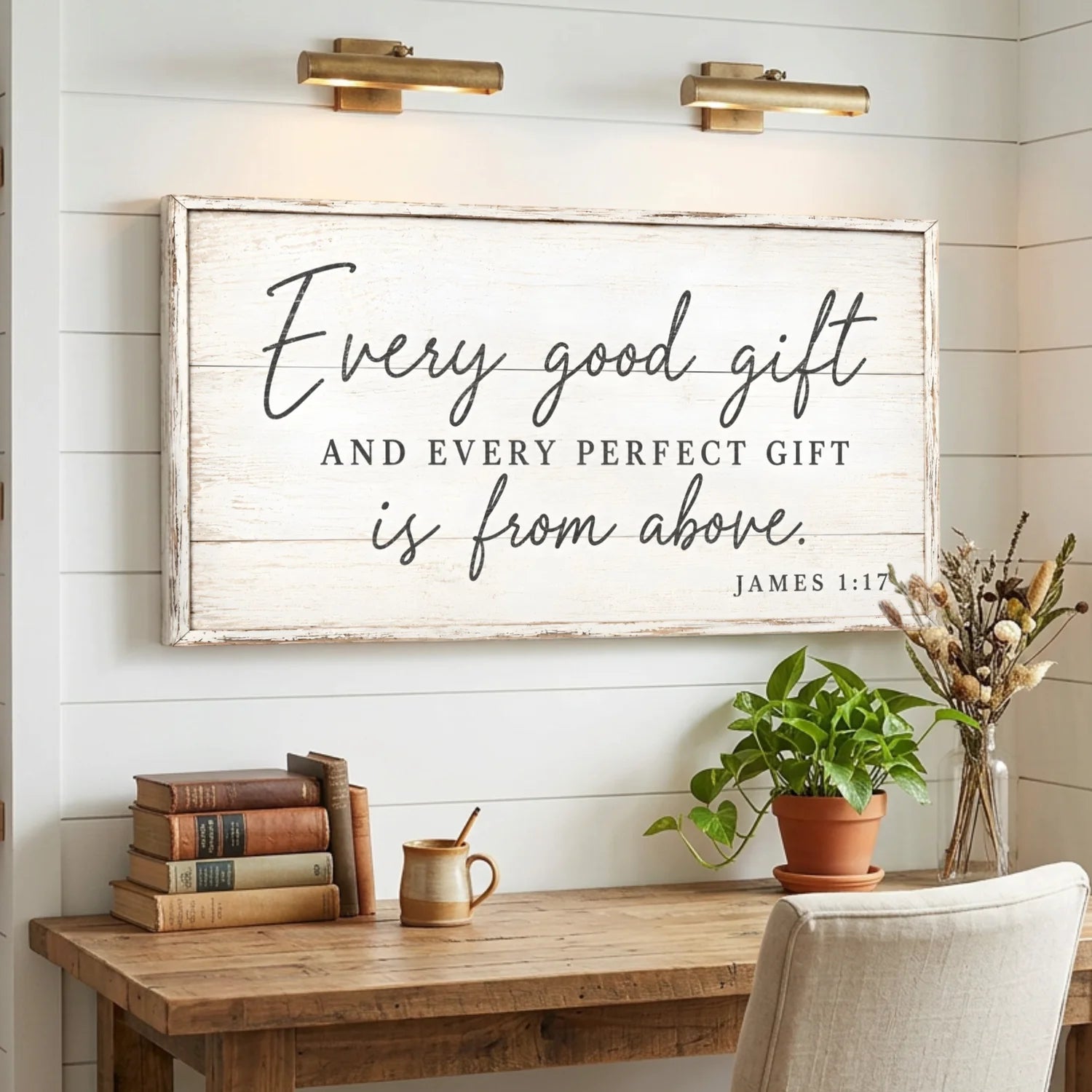 Decorative sign with inspirational quote above a wooden desk with books and plants. Every Perfect Gift Is From Above - James 1:17