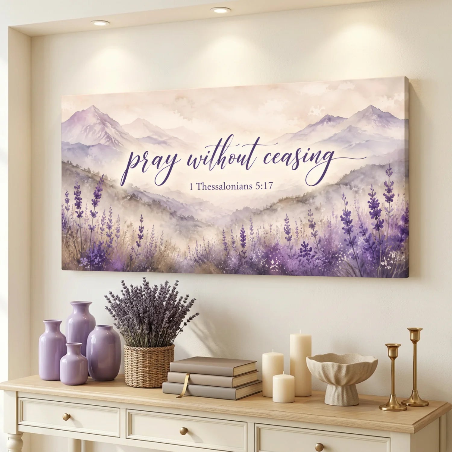 Decorative wall art with lavender and mountains on a wall above a console table with decor items.