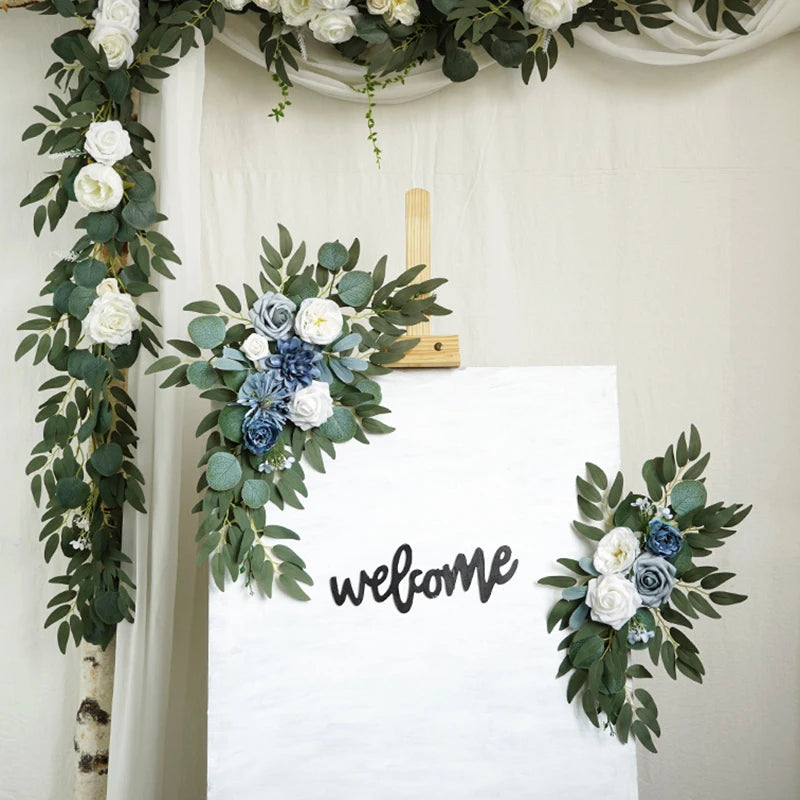 Artificial silk floral swag pair in champagne rose, shown on rustic wedding welcome sign backdrop.