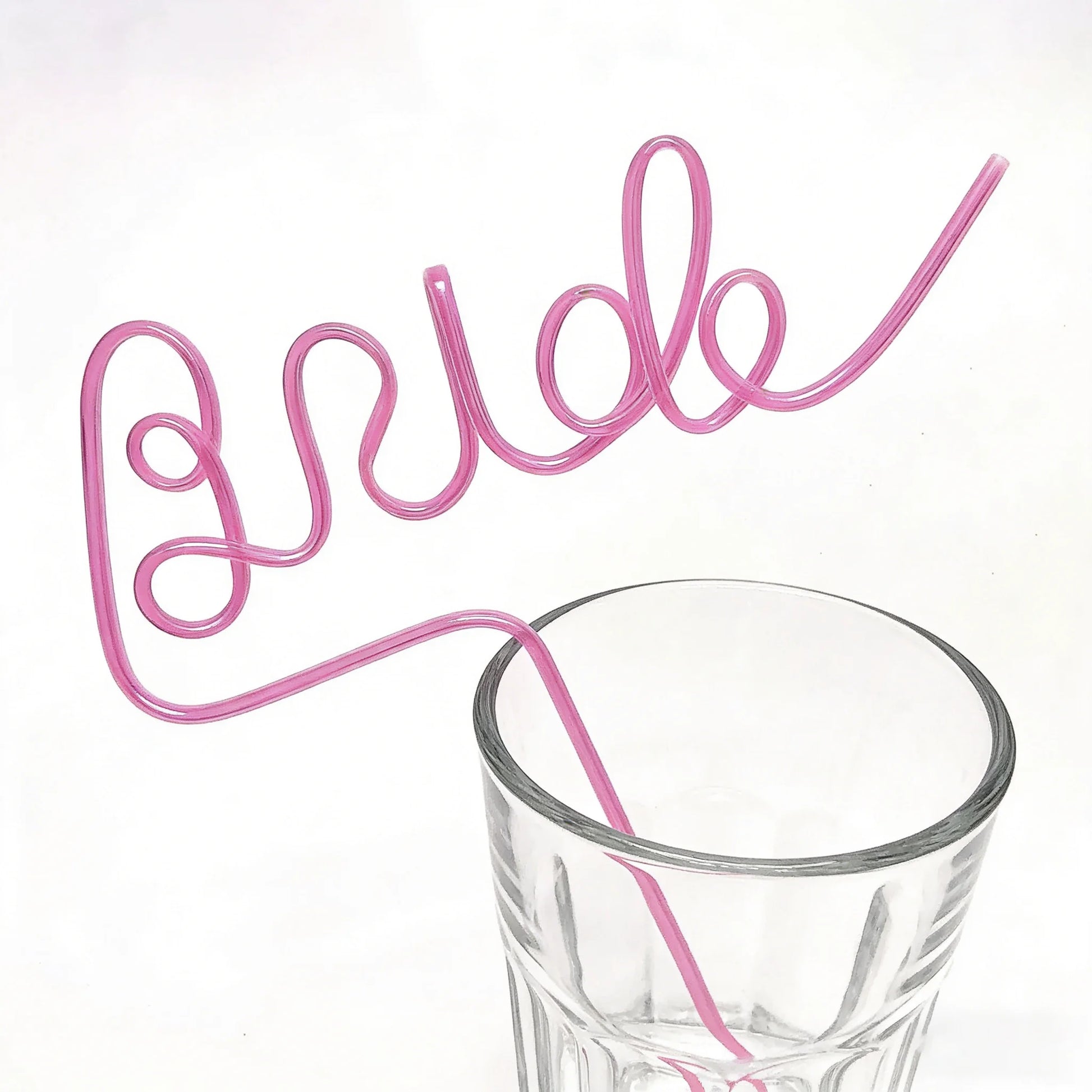 Pink bride drinking straw set for bachelorette party, shown in gift box bridal shower display.