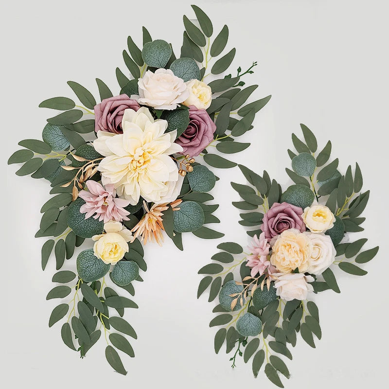 Artificial silk floral swag pair in champagne rose, shown on rustic wedding welcome sign backdrop.