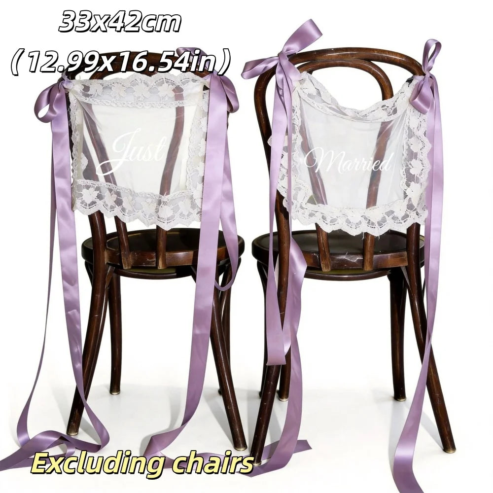 Sheer lace 'Just Married' chair sign set with 'Bride' and 'Groom' lettering, shown on wedding sweetheart table chair display.