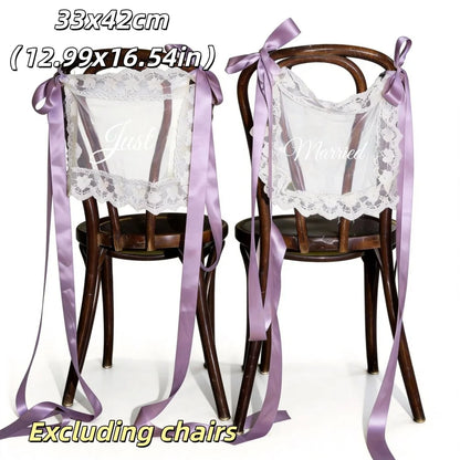 Sheer lace 'Just Married' chair sign set with 'Bride' and 'Groom' lettering, shown on wedding sweetheart table chair display.