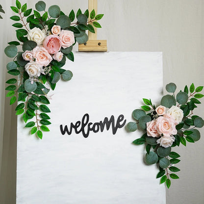 Artificial silk floral swag pair in champagne rose, shown on rustic wedding welcome sign backdrop.