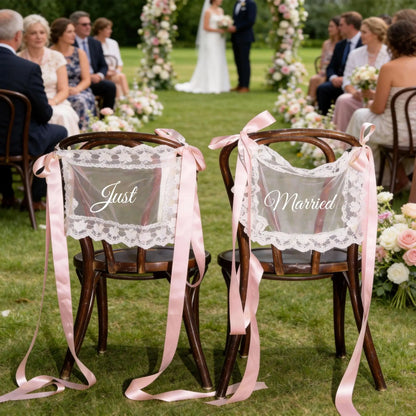 Sheer lace 'Just Married' chair sign set with 'Bride' and 'Groom' lettering, shown on wedding sweetheart table chair display.