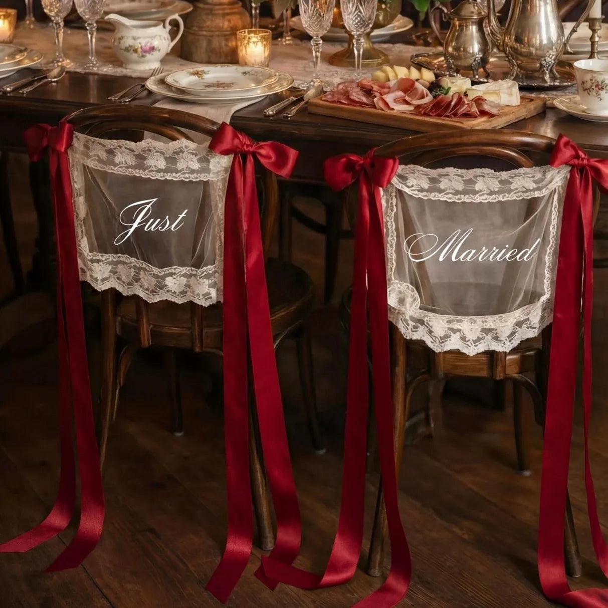 Sheer lace 'Just Married' chair sign set with 'Bride' and 'Groom' lettering, shown on wedding sweetheart table chair display.
