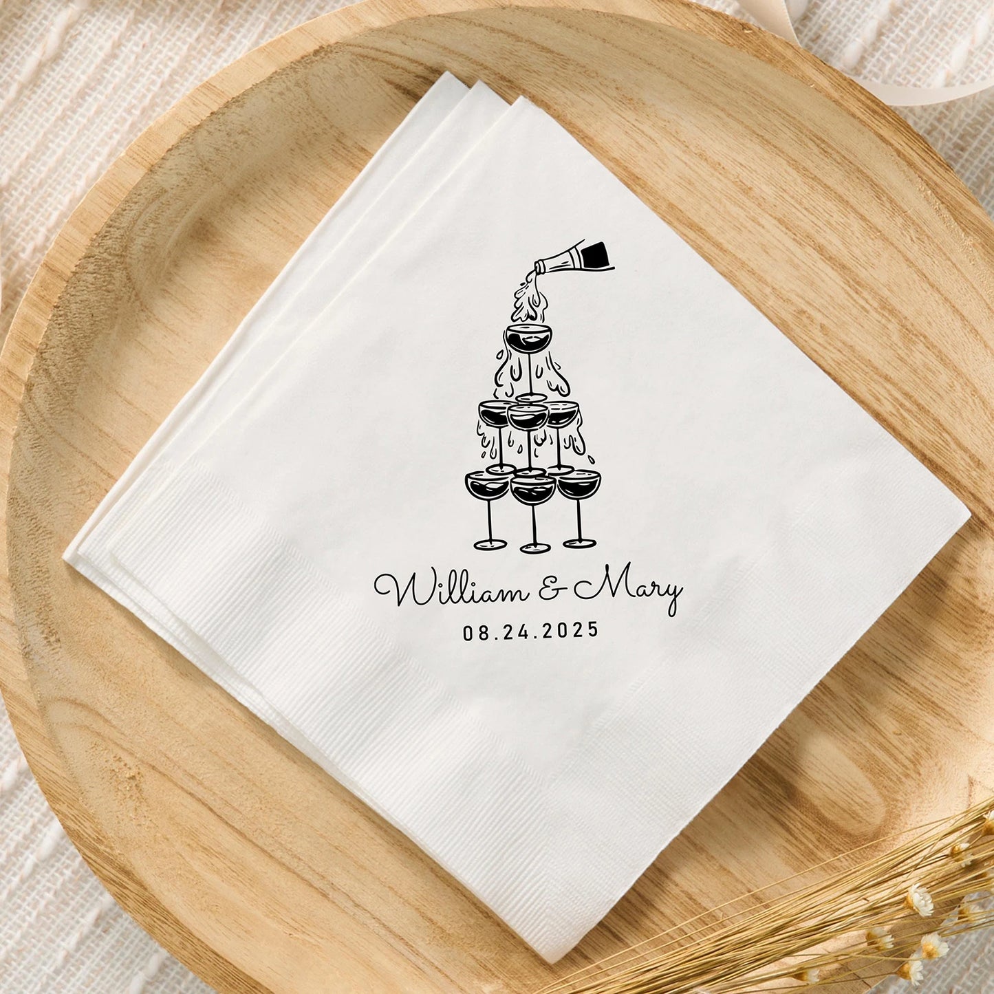 Custom monogram cocktail napkins personalized with names and wedding date, shown on wedding reception bar display.