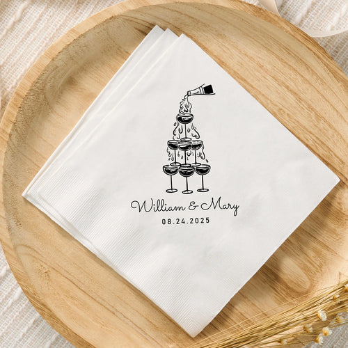 Custom monogram cocktail napkins personalized with names and wedding date, shown on wedding reception bar display.