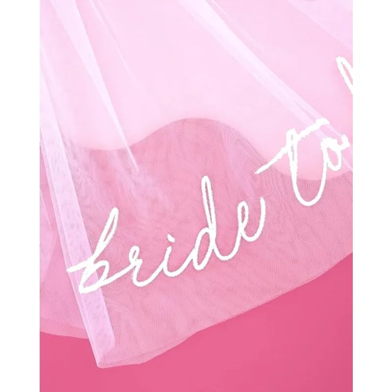 Bride to be white tulle headpiece veil, shown on bachelorette party accessory display.