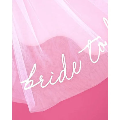 Bride to be white tulle headpiece veil, shown on bachelorette party accessory display.