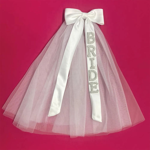 Bride to be pearl curvy veil in white tulle with satin bow, shown on bachelorette headpiece display.