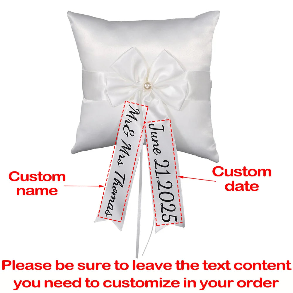 Personalized white flower girl basket and ring bearer pillow set with custom lettering, shown on wedding ceremony display.