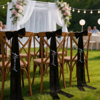 Elegant black 'Reserved' wedding chair seating ribbon, shown on ceremony chair display.
