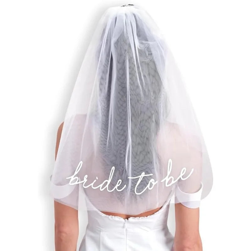 Bride to be white tulle headpiece veil, shown on bachelorette party accessory display.
