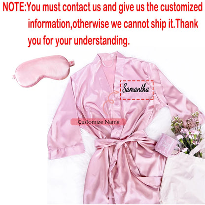 Personalized soft satin bridesmaid robe in custom pink with matching eye mask, shown on bachelorette gift display.