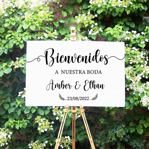 Personalized 'Bienvenidos' Spanish wedding welcome mirror decal in gold vinyl, shown on welcome sign board display.