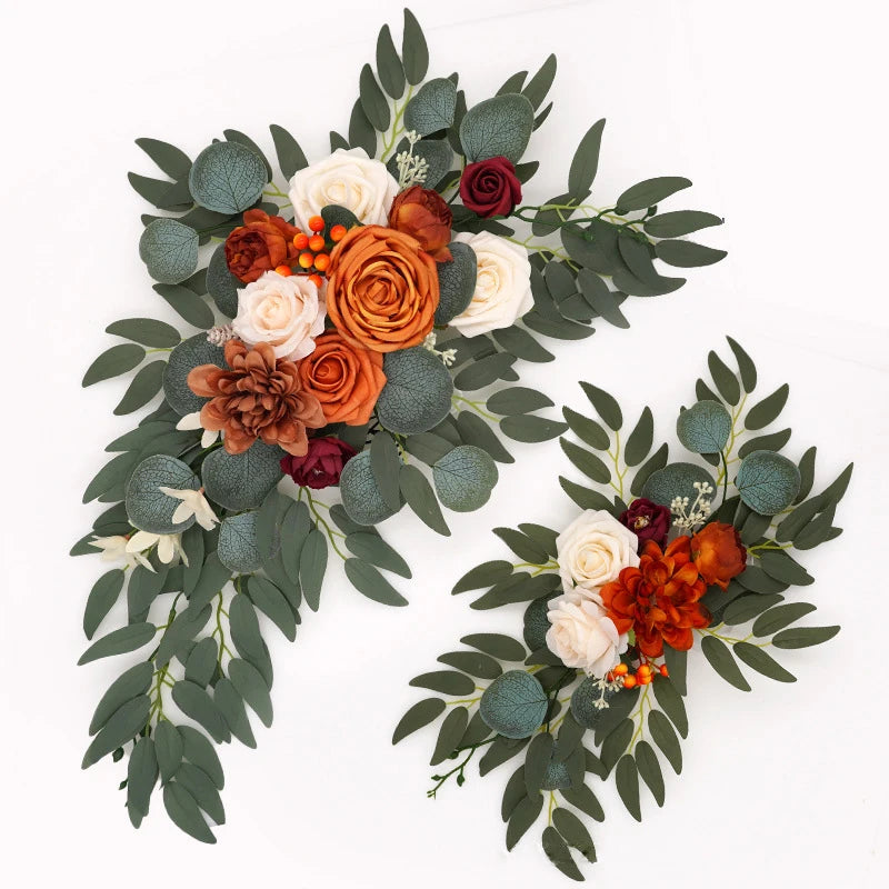 Artificial silk floral swag pair in champagne rose, shown on rustic wedding welcome sign backdrop.
