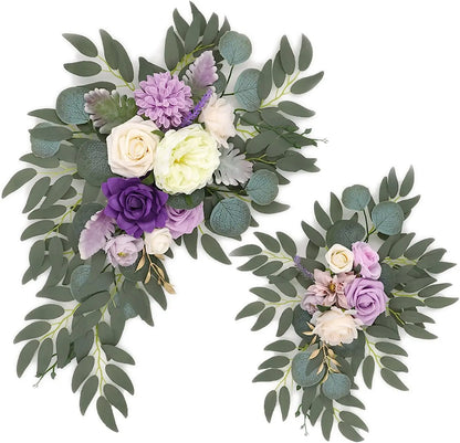 Artificial silk floral swag pair in champagne rose, shown on rustic wedding welcome sign backdrop.