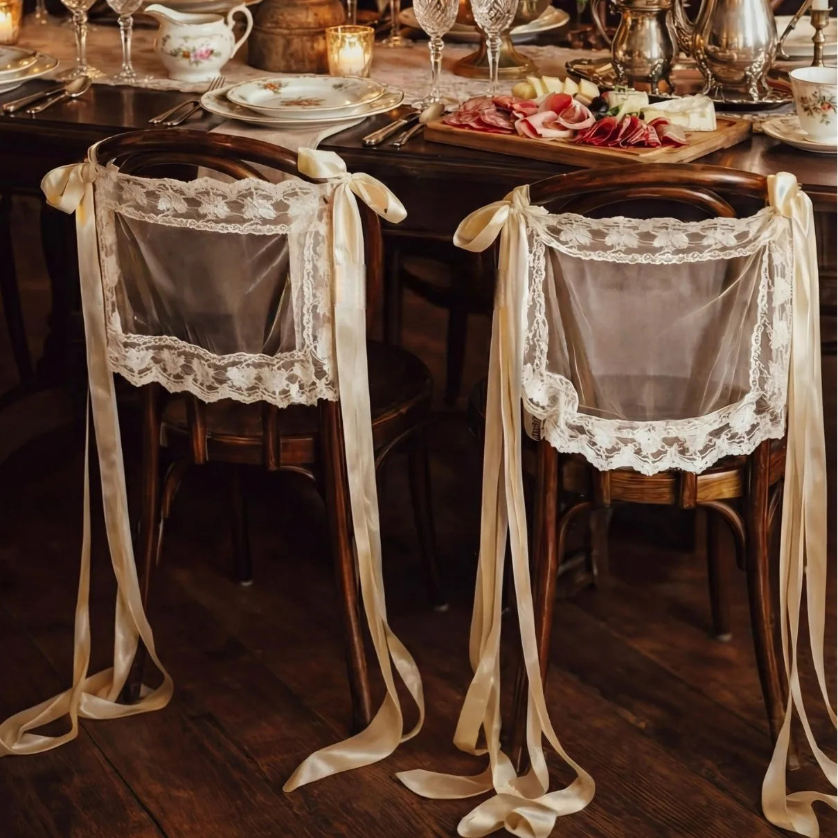 Sheer lace 'Just Married' chair sign set with 'Bride' and 'Groom' lettering, shown on wedding sweetheart table chair display.