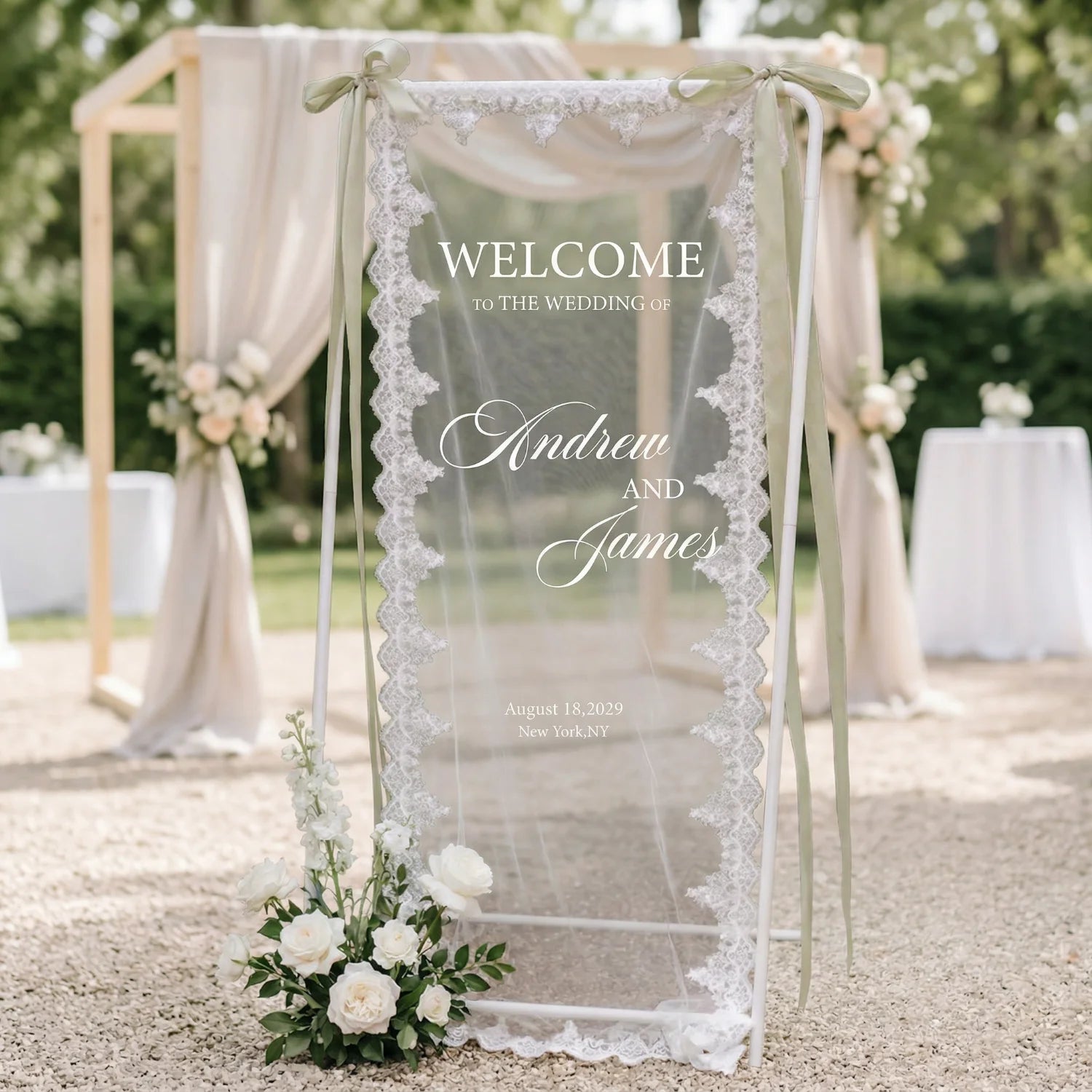 Personalized lace fabric wedding welcome banner with embroidered custom names and date, shown on outdoor ceremony display.