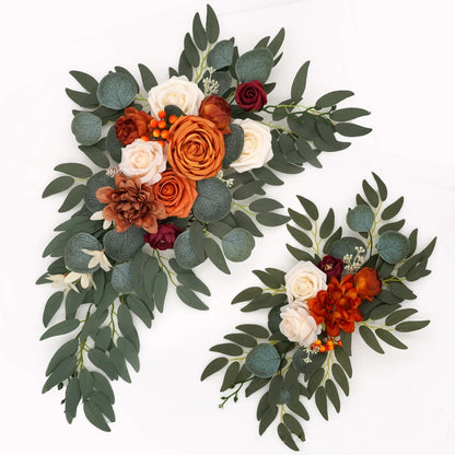 Artificial silk floral swag pair in champagne rose, shown on rustic wedding welcome sign backdrop.