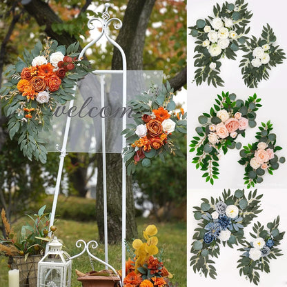 Artificial silk floral swag pair in champagne rose, shown on rustic wedding welcome sign backdrop.