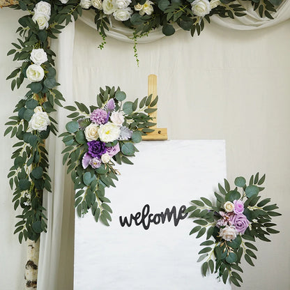 Artificial silk floral swag pair in champagne rose, shown on rustic wedding welcome sign backdrop.
