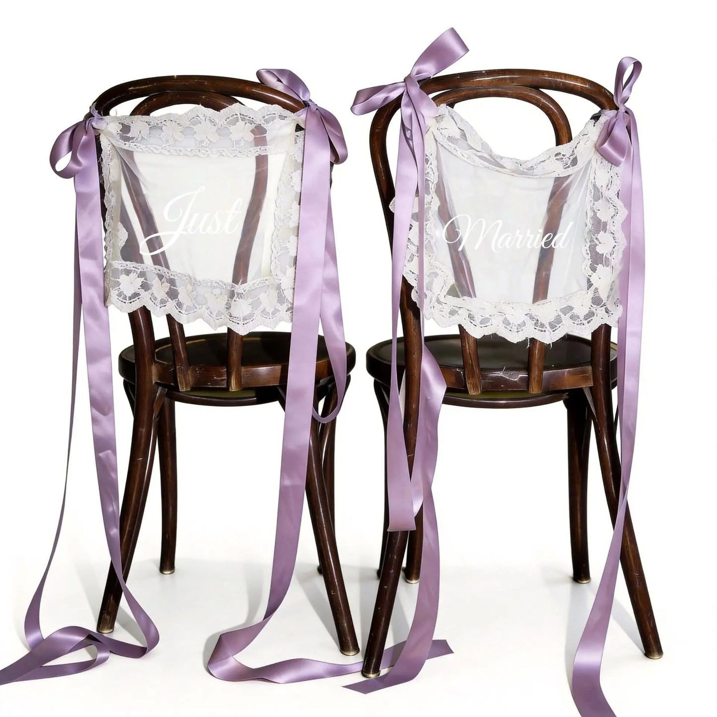 Sheer lace 'Just Married' chair sign set with 'Bride' and 'Groom' lettering, shown on wedding sweetheart table chair display.
