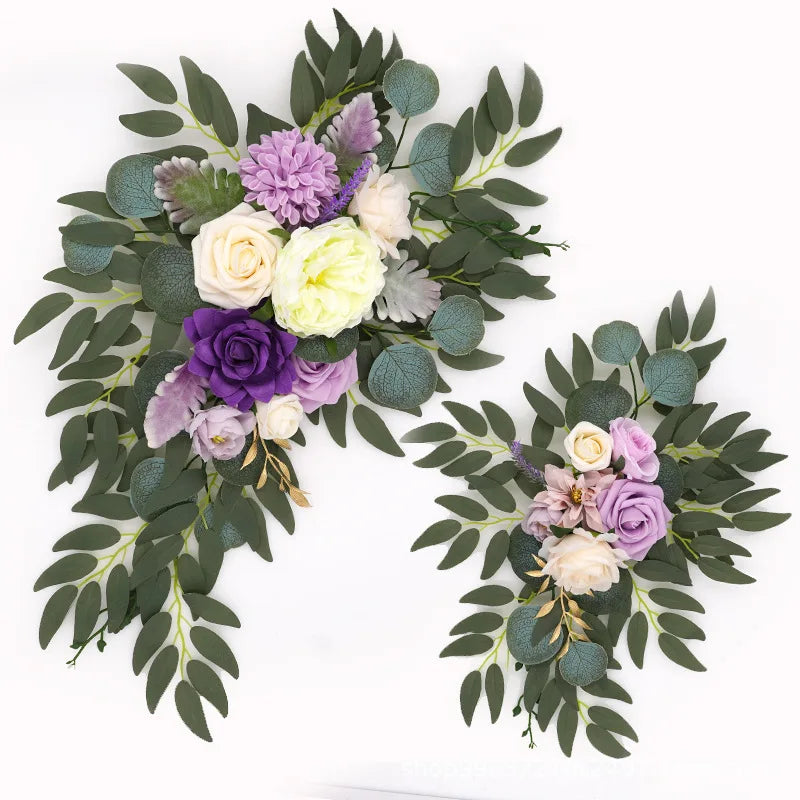 Artificial silk floral swag pair in champagne rose, shown on rustic wedding welcome sign backdrop.
