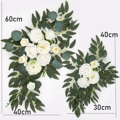 Artificial silk floral swag pair in champagne rose, shown on rustic wedding welcome sign backdrop.