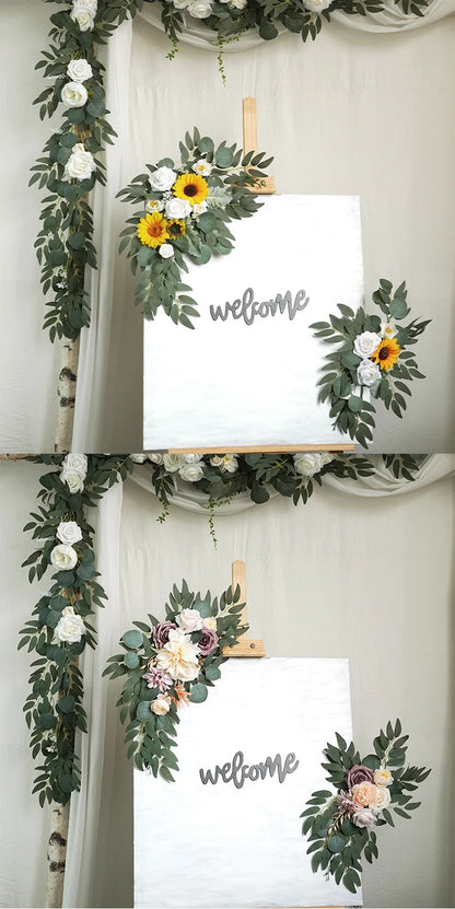 Artificial silk floral swag pair in champagne rose, shown on rustic wedding welcome sign backdrop.