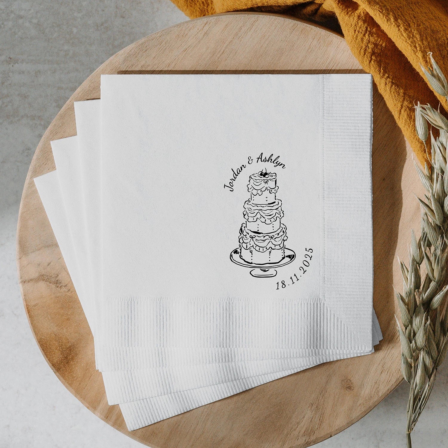 Custom monogram cocktail napkins personalized with names and wedding date, shown on wedding reception bar display.
