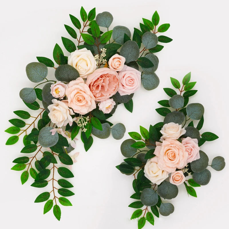 Artificial silk floral swag pair in champagne rose, shown on rustic wedding welcome sign backdrop.